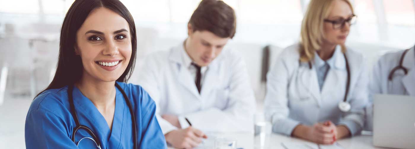 several doctors at a meeting smiling